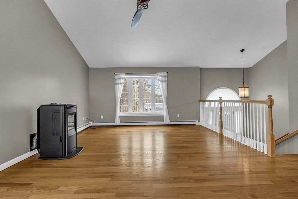 535 Clark Street Gardner, MA 01440 - Photo 15 of 41 a view of an empty room with a window and wooden floor