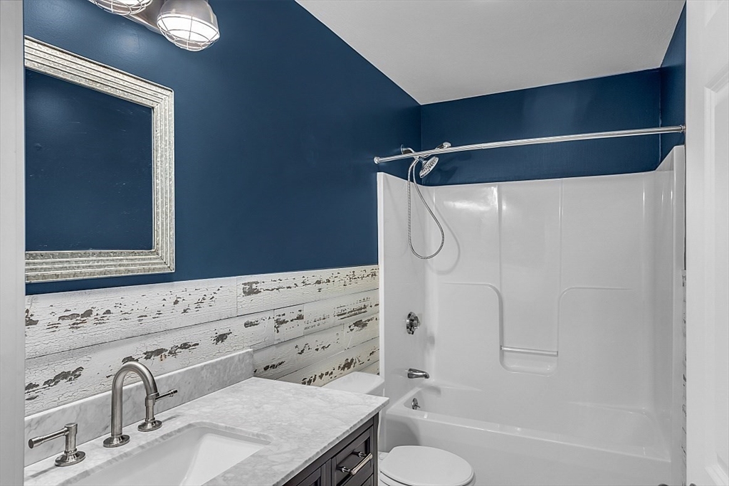 535 Clark Street Gardner, MA 01440 - Photo 16 of 41 a bathroom with a granite countertop sink toilet and shower