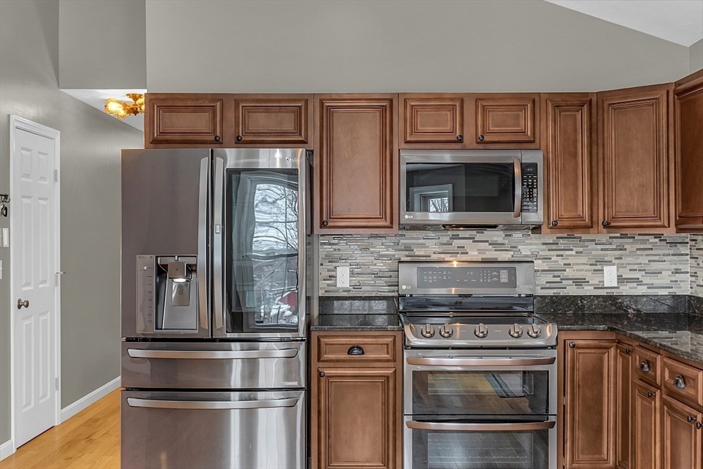 535 Clark Street Gardner, MA 01440 - Photo 7 of 41 a kitchen with stainless steel appliances granite countertop a stove microwave and refrigerator