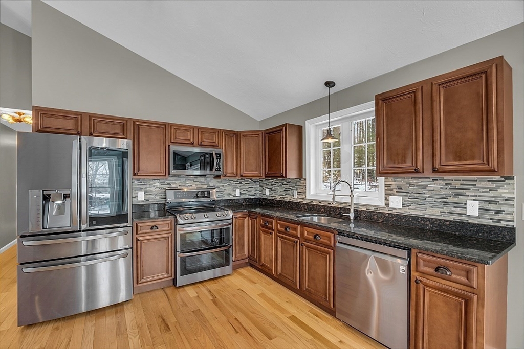 535 Clark Street Gardner, MA 01440 - Photo 9 of 41 a kitchen with stainless steel appliances granite countertop a sink stove and refrigerator
