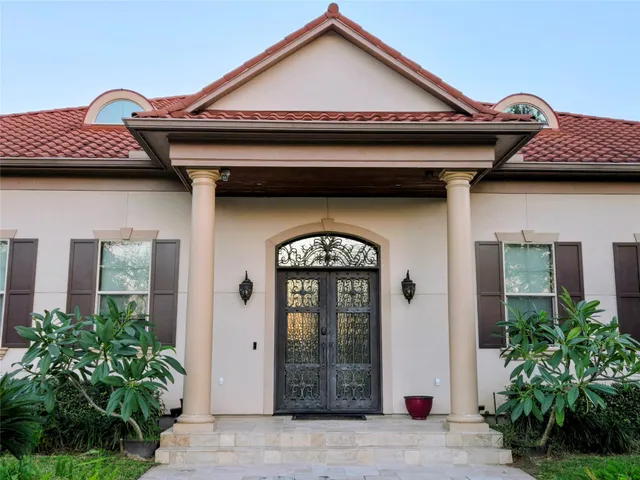 a view of an empty room with a fireplace and windows