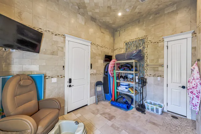 a living room with stainless steel appliances furniture and a wooden floor