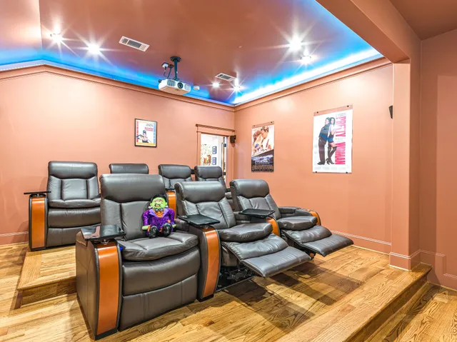 a living room with stainless steel appliances kitchen island granite countertop furniture and wooden floor