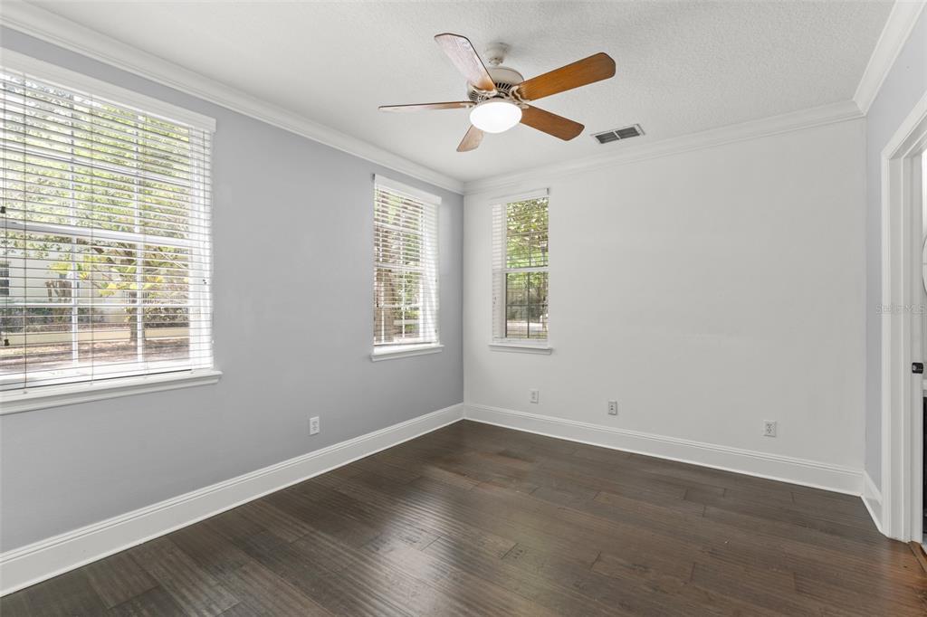 1563 Common Way Road Orlando, FL 32814 - Photo 35 of 47 an empty room with wooden floor fan and windows