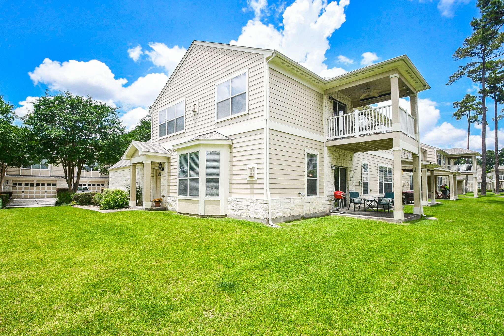 13600 Breton Ridge Street, Unit 36F Houston, TX 77070 - Photo 32 of 38 Rear exterior showcasing the home's inviting outdoor spaces.