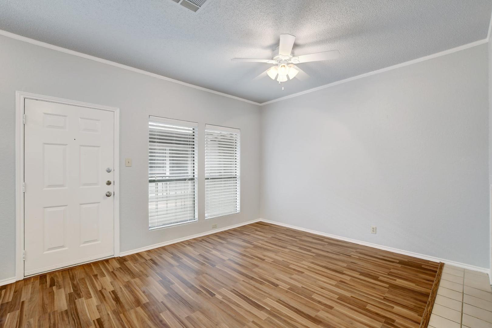 2804 Rio Grande Street, Unit 310 Austin, TX 78705 - Photo 15 of 22 A well-lit room with wood flooring, clean walls, and a convenient entryway.