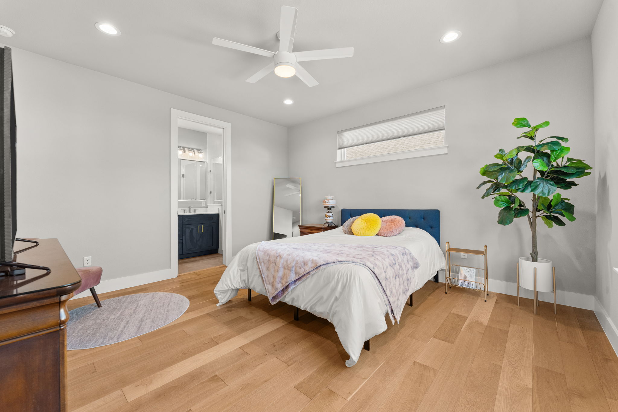 1116 Stobaugh Street, Unit A Austin, TX 78757 - Photo 19 of 37 a bedroom with a bed and a potted plant
