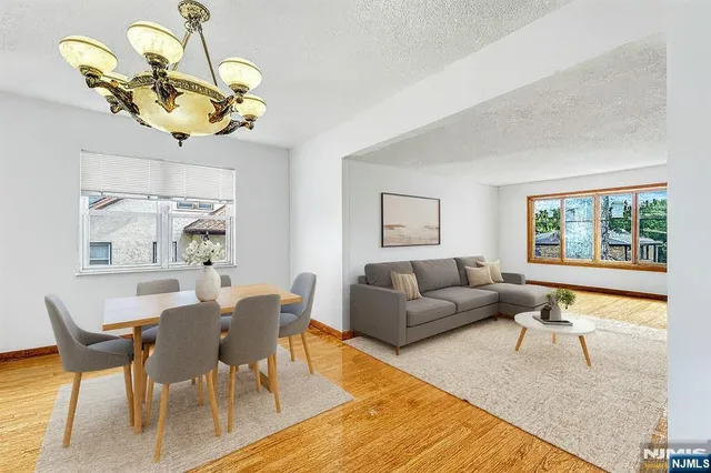 a living room with a couch chandelier and a window