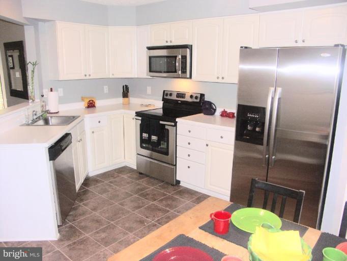4264 Maple Path Circle, Unit 4 Nottingham, MD 21236 - Photo 2 of 17 a kitchen with a sink refrigerator and microwave