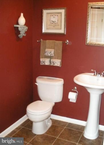 4264 Maple Path Circle, Unit 4 Nottingham, MD 21236 - Photo 6 of 17 a bathroom with a toilet a sink and mirror