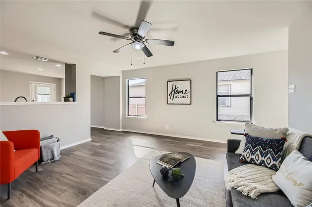 a living room with furniture and wooden floor