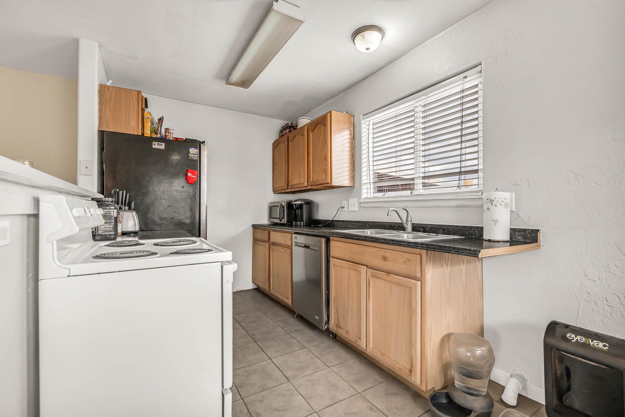 389 Sunnyside Circle, Unit A Grand Junction, CO 81504 - Photo 12 of 21 a kitchen with granite countertop a sink stove and cabinets