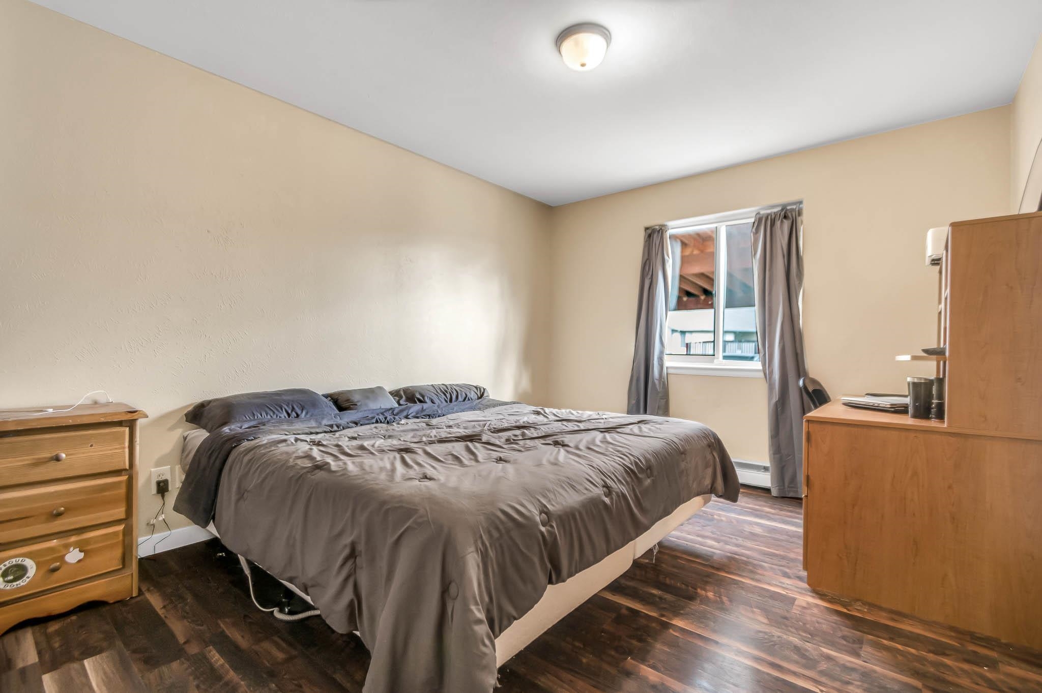 389 Sunnyside Circle, Unit A Grand Junction, CO 81504 - Photo 15 of 21 a bedroom with a bed and wooden floor