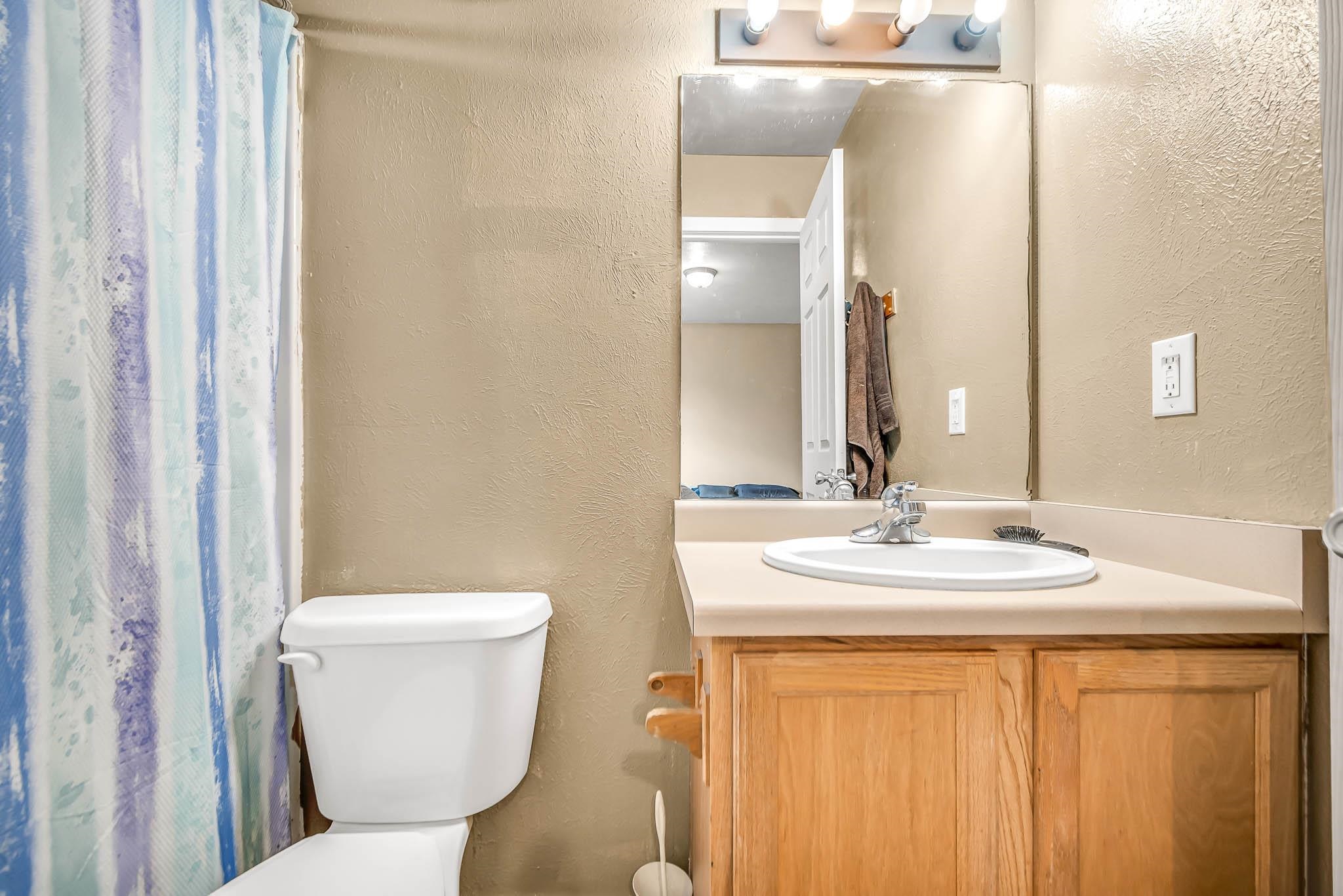 389 Sunnyside Circle, Unit A Grand Junction, CO 81504 - Photo 16 of 21 a bathroom with a toilet sink and mirror