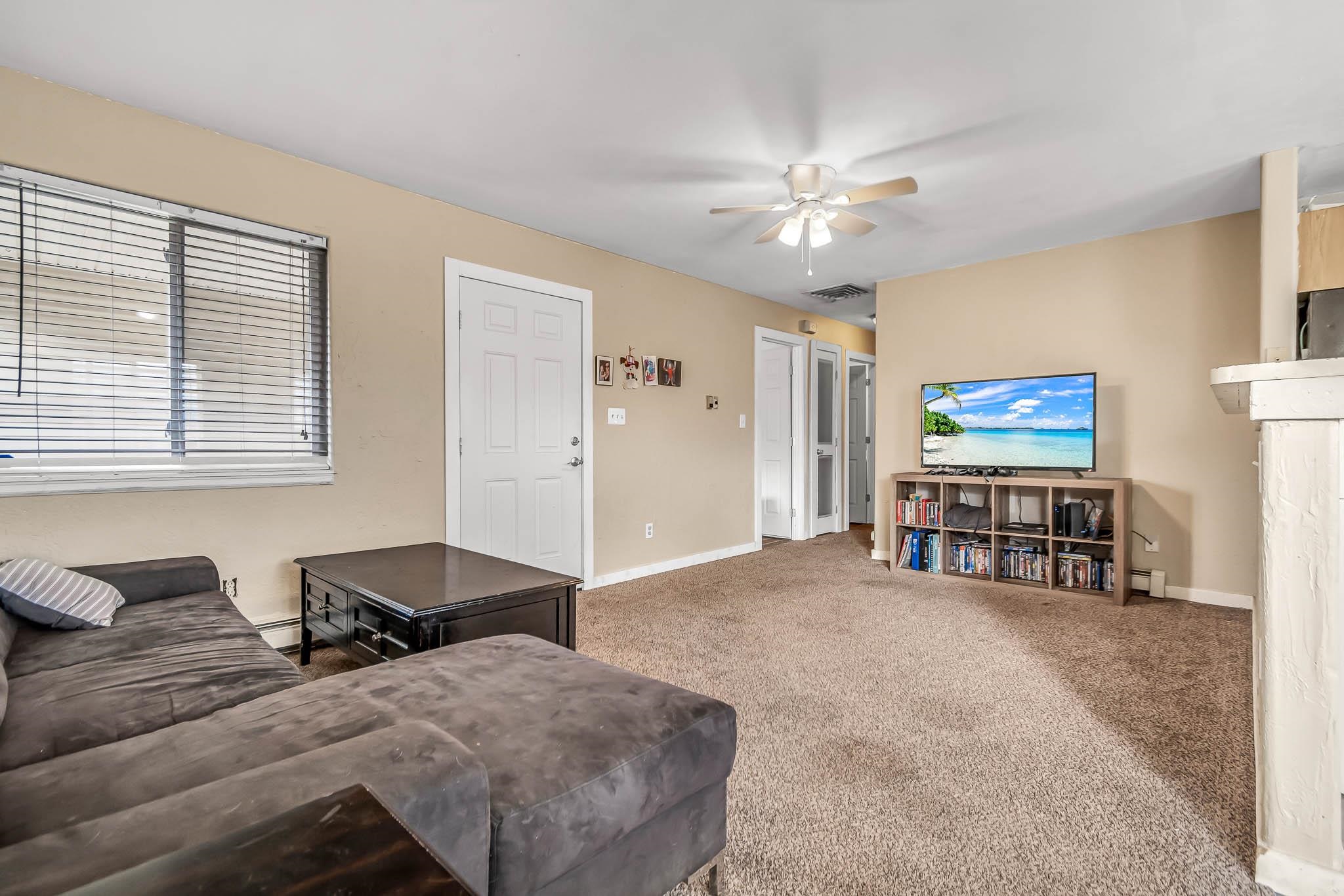 389 Sunnyside Circle, Unit A Grand Junction, CO 81504 - Photo 7 of 21 a living room with furniture and a flat screen tv