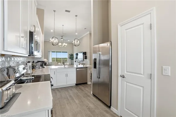 a kitchen with refrigerator and cabinets