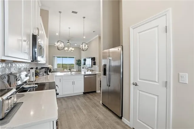 a kitchen with refrigerator and cabinets