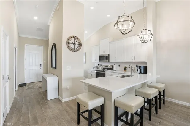a view of a dining room with furniture a chandelier and wooden floor