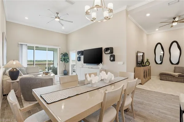 a living room with furniture a large window and a flat screen tv