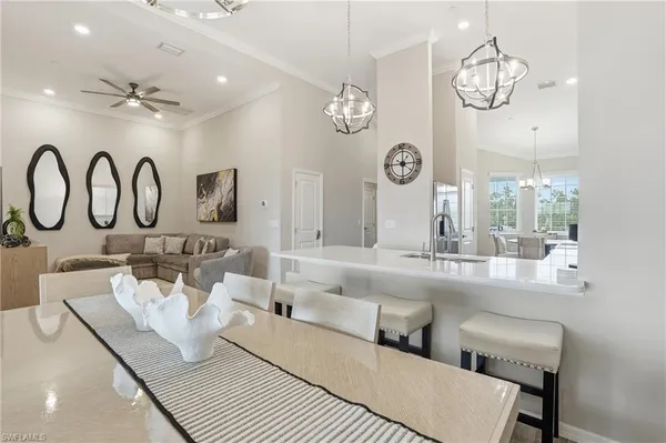 a large white kitchen with a large window and a clock