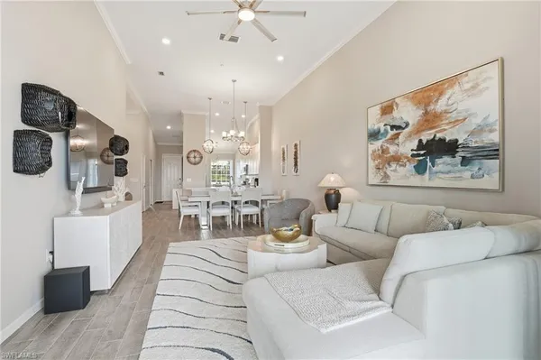 a living room with furniture and a chandelier