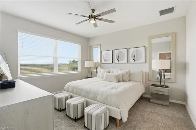 a bedroom with a bed and a large window