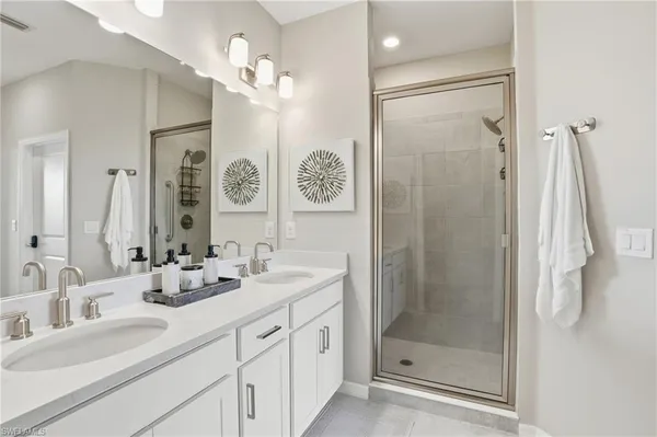 a bathroom with a shower sink vanity and mirror