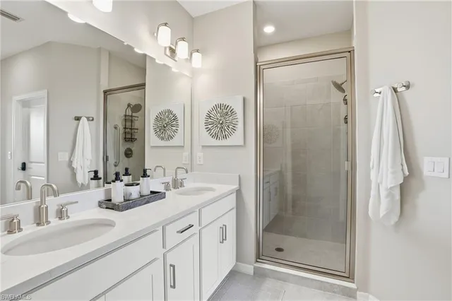 a bathroom with a shower sink vanity and mirror