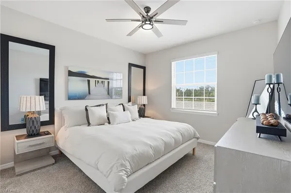 a bedroom with a bed and a large mirror