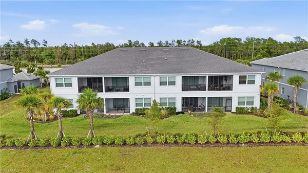 a view of a house with swimming pool and a yard