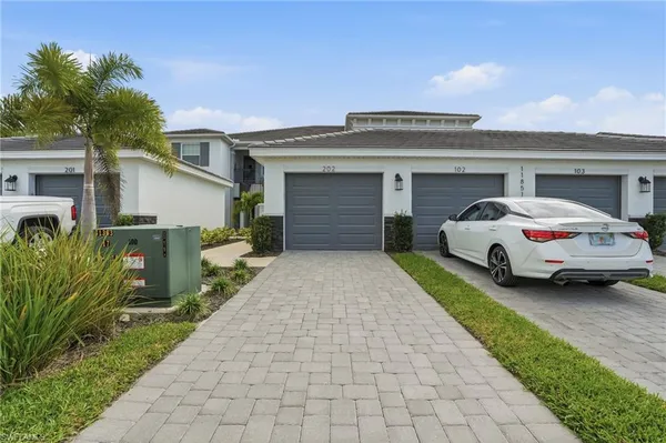 a car parked in front of white house