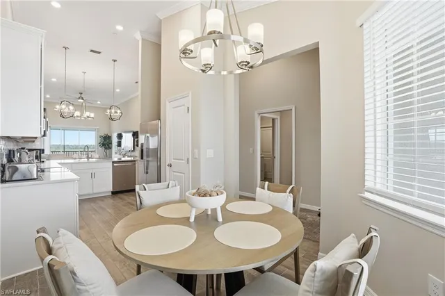 a view of a dining room with furniture and a chandelier