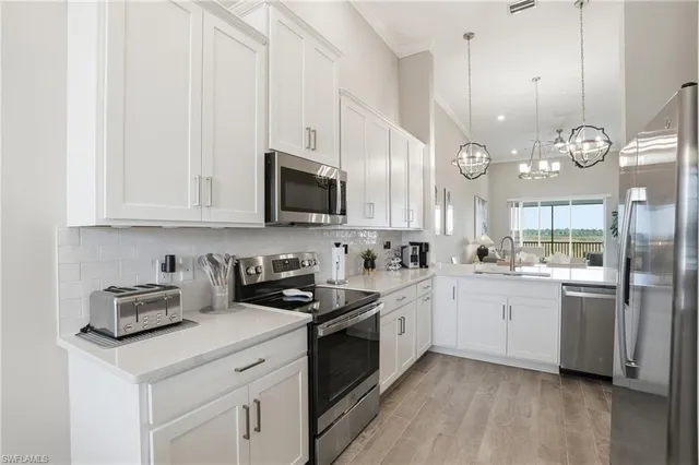 a kitchen with a sink stove and microwave