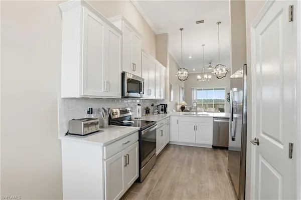 a kitchen with cabinets and appliances