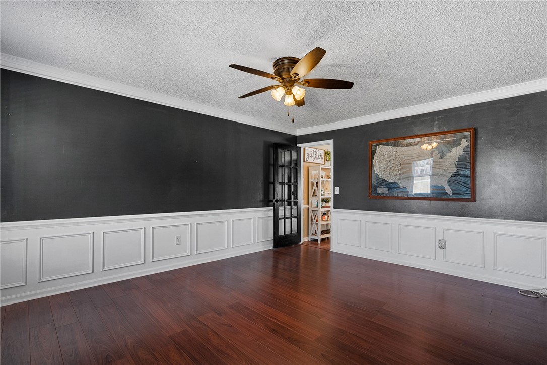 112 C-10-220 Anderson, SC 29621 - Photo 8 of 45 This versatile room features warm hardwood floors and elegant wainscoting.