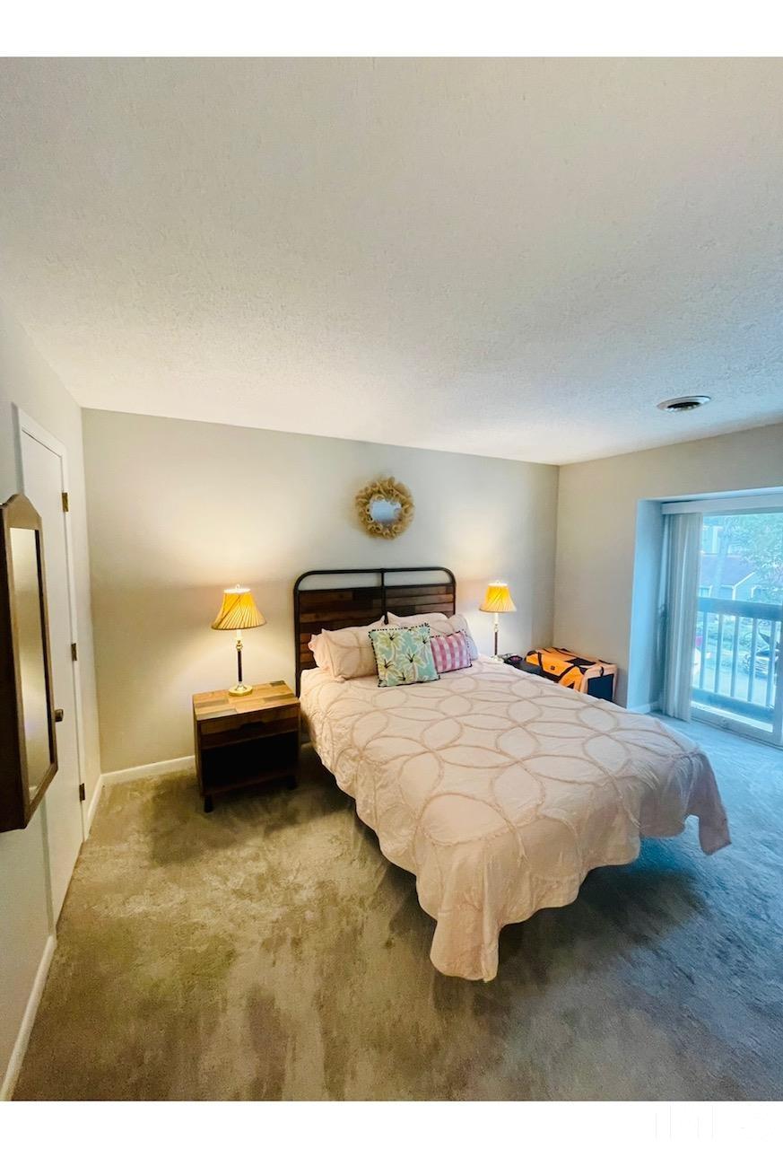 825 Green Ridge Drive Raleigh, NC 27609 - Photo 9 of 10 a bedroom with a bed and a night stand