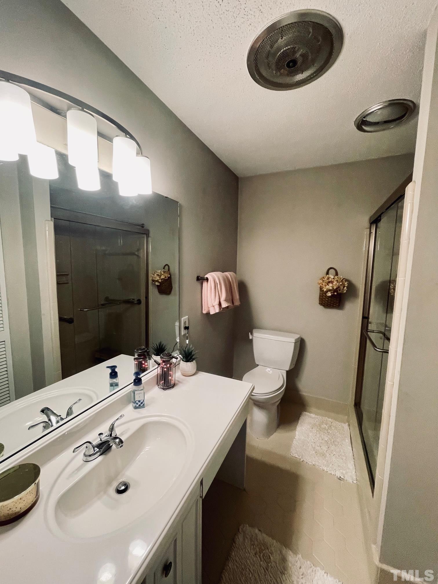 825 Green Ridge Drive Raleigh, NC 27609 - Photo 10 of 10 a bathroom with a sink and a mirror