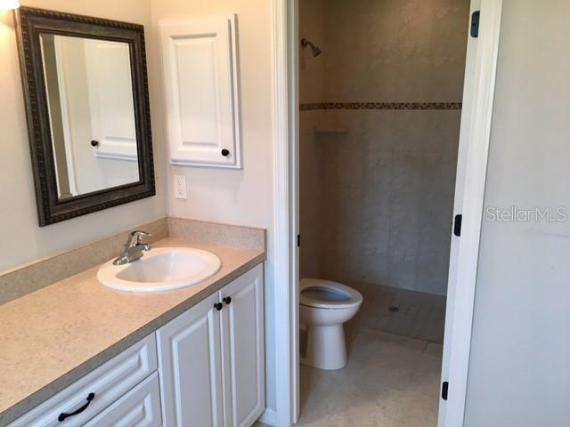 641 Constance Road Venice, FL 34293 - Photo 13 of 16 a bathroom with a sink and a mirror
