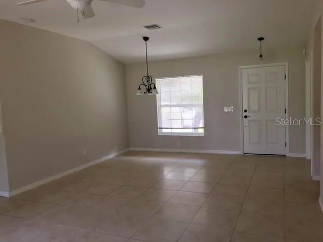 an empty room with windows and entrance