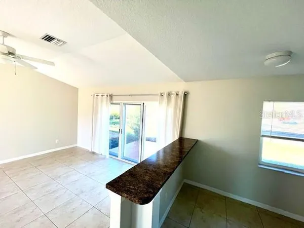 a view of a bathroom with bathtub and windows