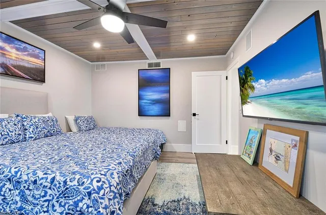 a bedroom with bed and a chandelier