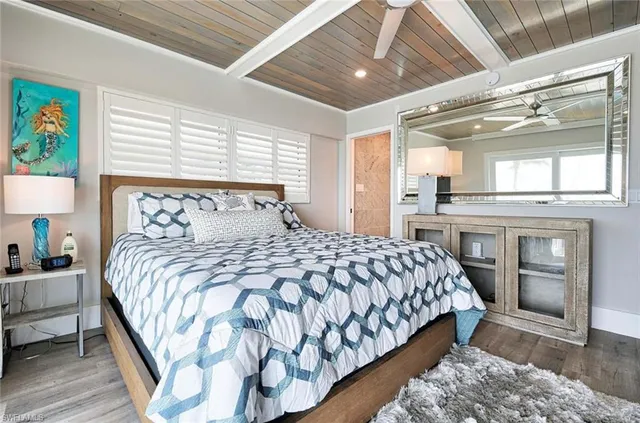 a bedroom with a large bed and a large window