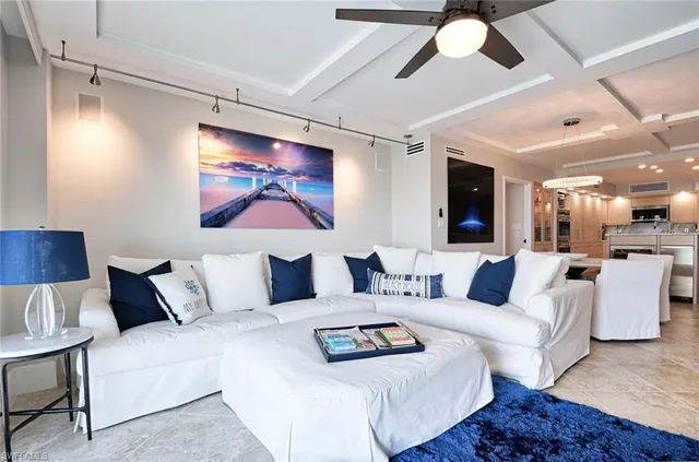 a living room with furniture and a painting on the wall