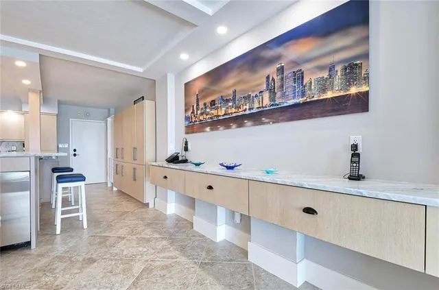 a large kitchen with stainless steel appliances a sink and cabinets