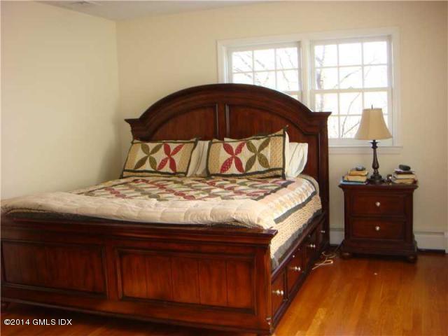 16 MacKenzie Glen Greenwich, CT 06830 - Photo 15 of 26 a bedroom with a bed and a window