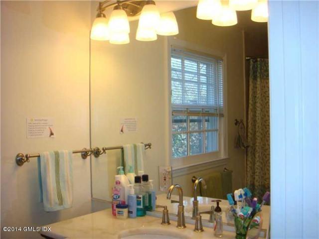 16 MacKenzie Glen Greenwich, CT 06830 - Photo 19 of 26 a bathroom with a sink and a mirror