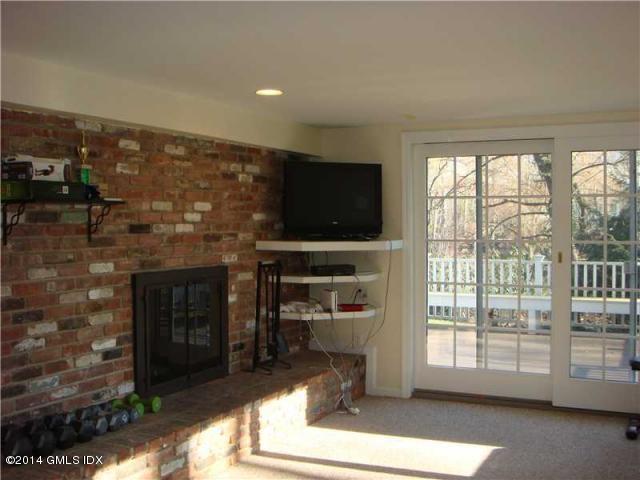 16 MacKenzie Glen Greenwich, CT 06830 - Photo 21 of 26 a living room with fireplace furniture and a flat screen tv