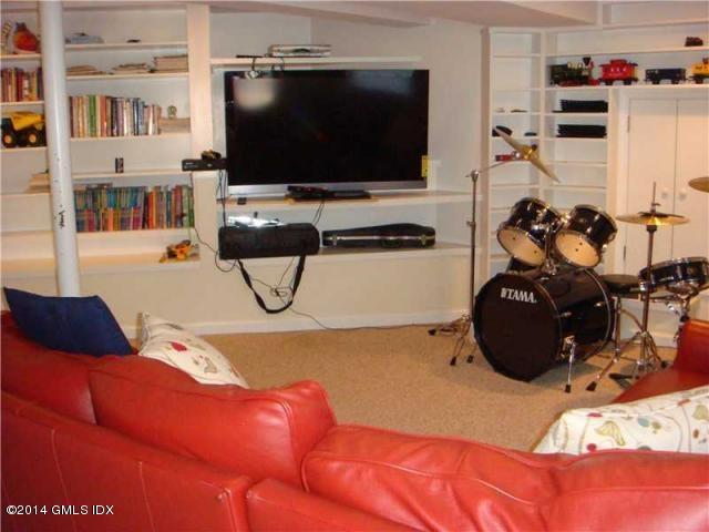 16 MacKenzie Glen Greenwich, CT 06830 - Photo 22 of 26 a living room with furniture and a flat screen tv