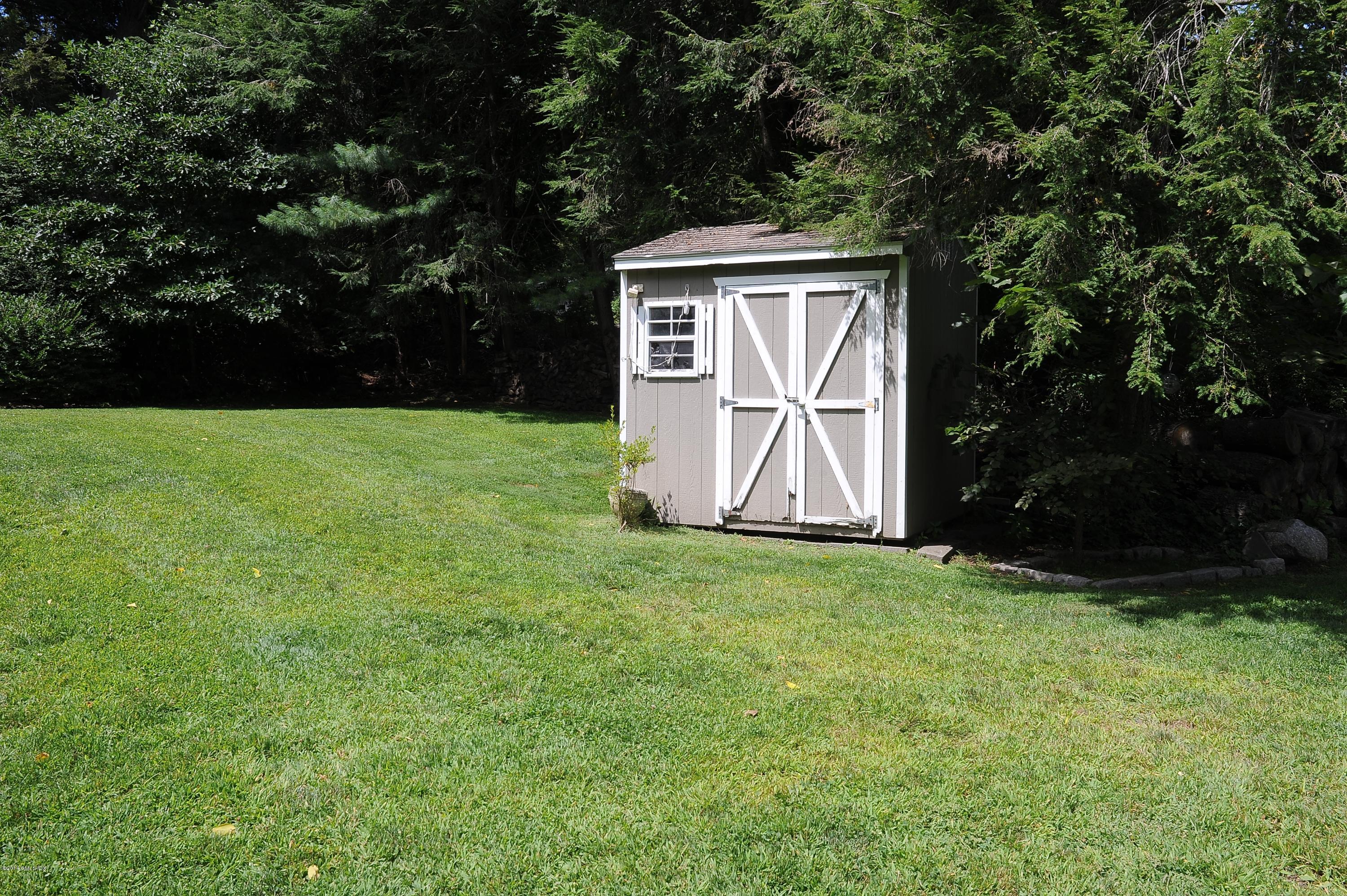 16 MacKenzie Glen Greenwich, CT 06830 - Photo 26 of 26 a view of a tiny house with backyard