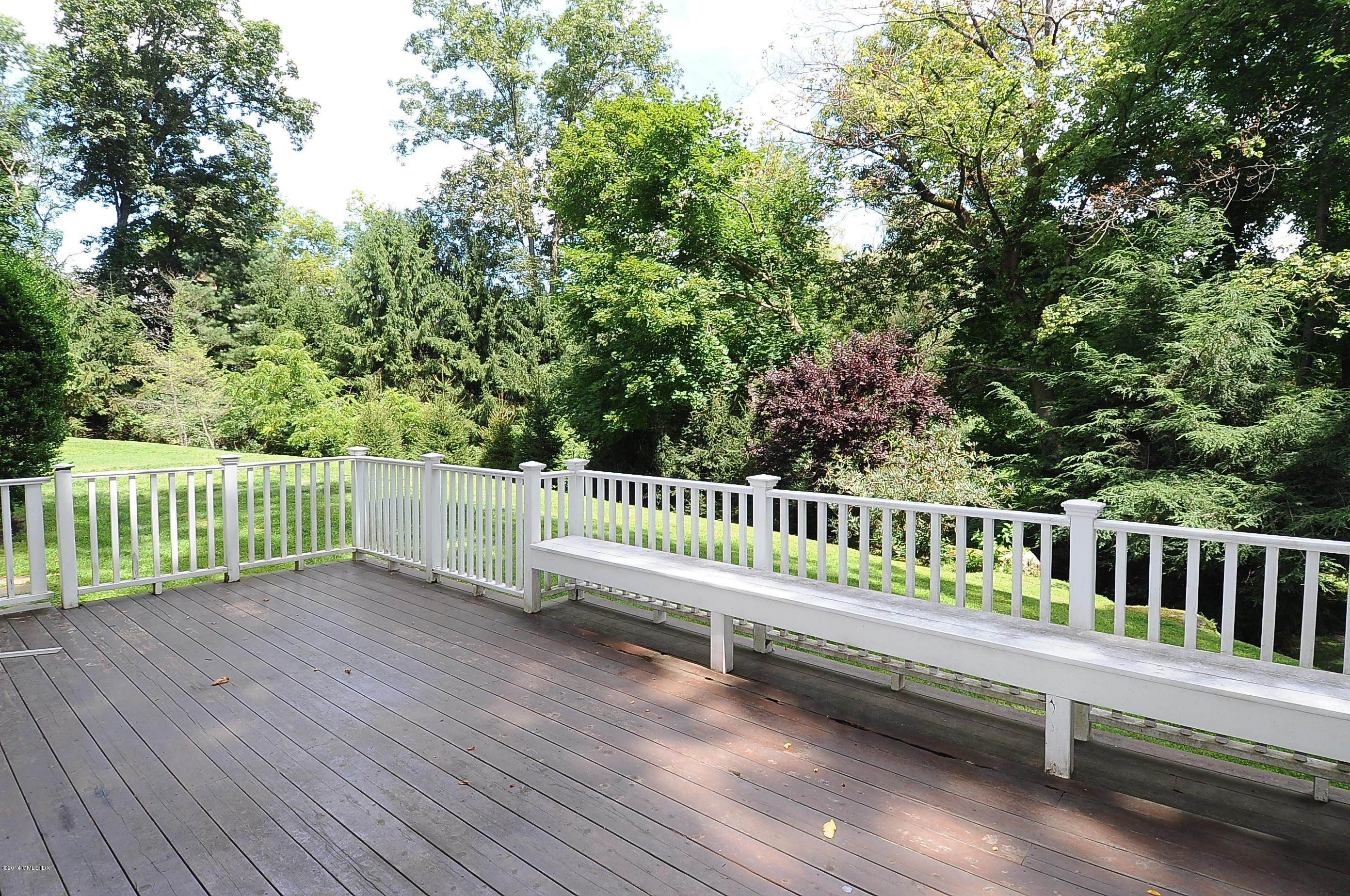 16 MacKenzie Glen Greenwich, CT 06830 - Photo 3 of 26 a view of a deck with a small yard